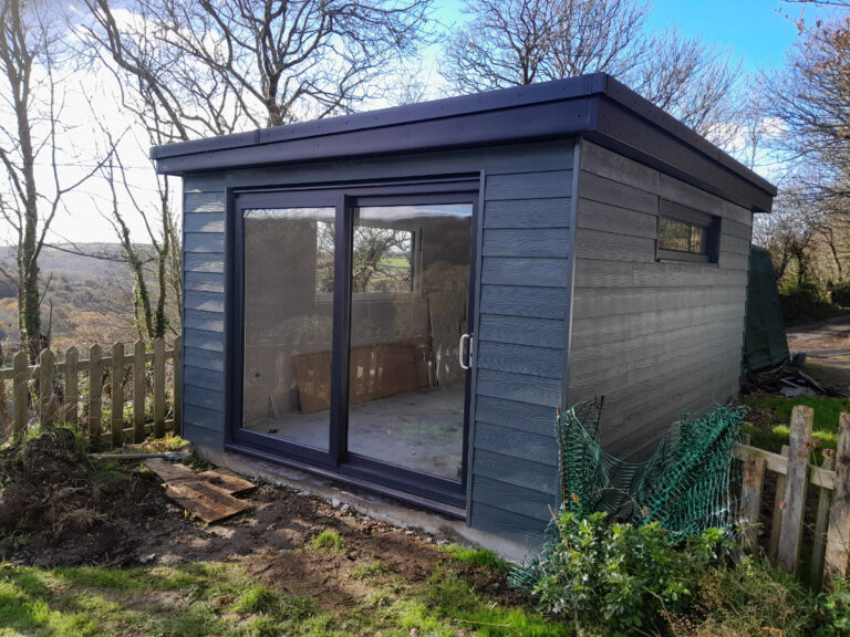 “Attractive garden office, creating a well-designed workspace surrounded by nature, providing a tranquil and productive environment for remote work or creative endeavors."